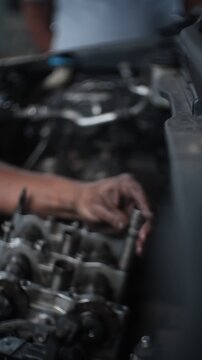 car mechanic changing car engine