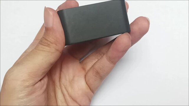 Compact electronic adapter showing USB Type A port on white background. Portable device charger utility item