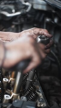 car mechanic changing car engine