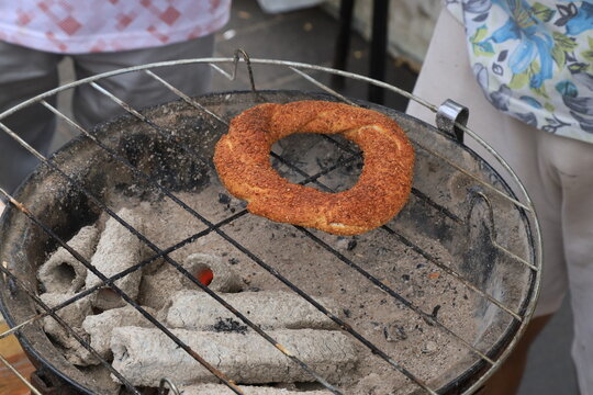 A traditional Turkish simit baked over a coal fire