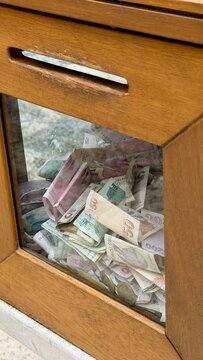 harity donation box with turkish lira at historic Eyup Sultan Mosque in Istanbul. Islamic sadaqah and zakat obligation, ramadan holy month celebration, muslim community and faith concept.