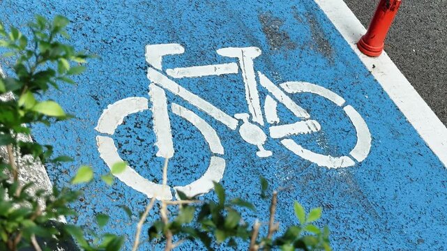 Close up of White Bicycle Lane Symbol stencil Painted on Asphalt city road