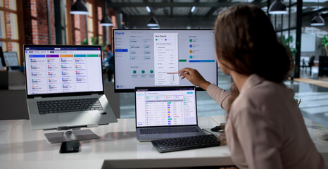 Woman Uses Payroll Software On Laptop