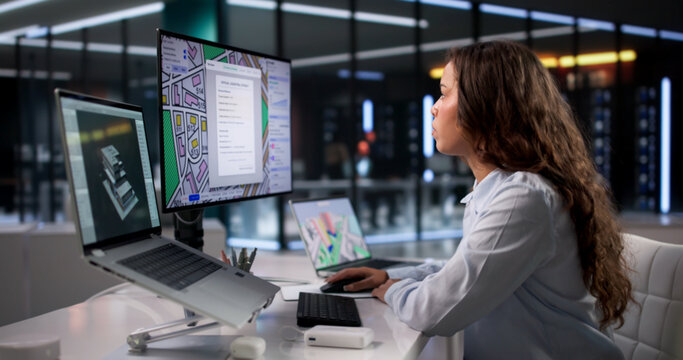 Young Woman Uses Software On Laptop