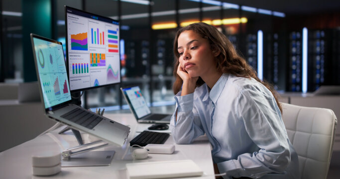 Woman Looks Overwhelmed While Analyzing Business Data