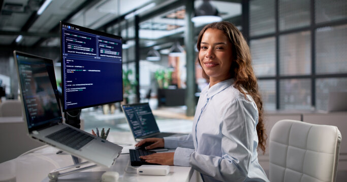 Young Woman Coder Happily Typing New Software Code On Laptop