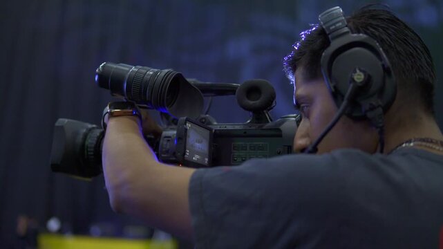 Professional cameraman operating a broadcast television camera