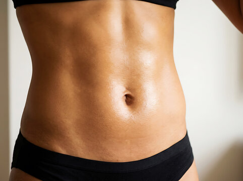 Close up of toned human abdomen with black underwear and skin belly navel
