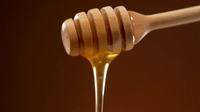 Honey dripping slowly from wooden spoon, warm studio lighting, high detail viscosity texture