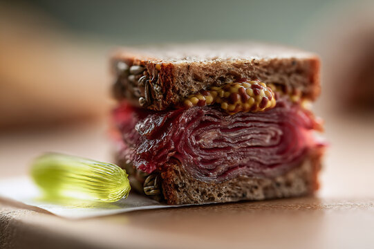 Miniature tilt shift pastrami sandwich on rye with microscopic mustard and tiny pickle spear