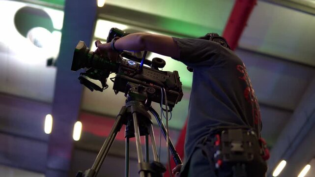 Professional camera operator filming live event broadcast