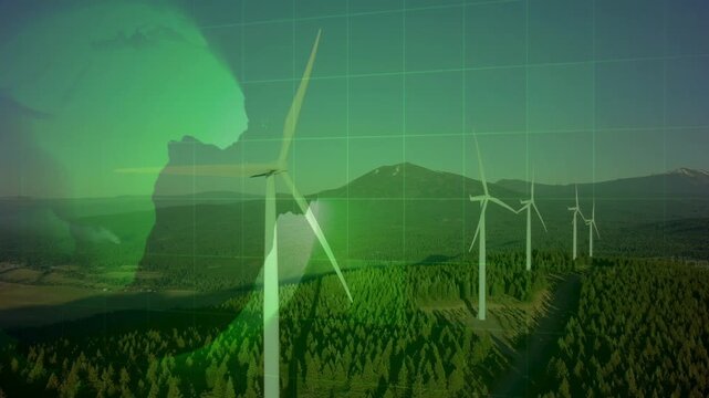 Wind turbines in a mountain area overlaid with a glowing green earth map and digital grid. Represents renewable energy monitoring and a global smart grid.