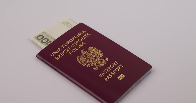 Polish passport with money inside of it, border corruption and travel document concept