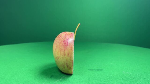 Sliced pear on green background, close-up pear slice