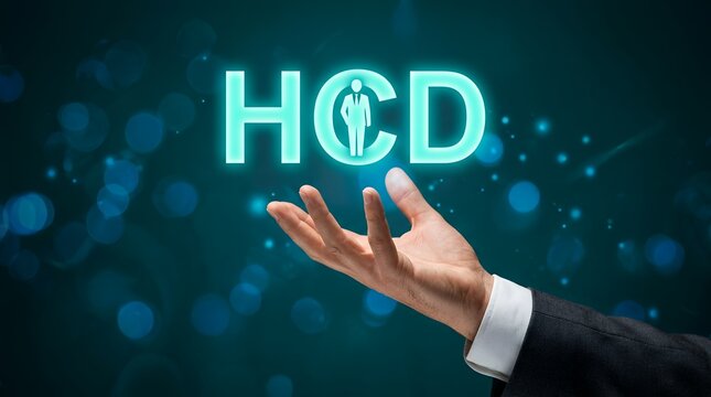 A businessman's outstretched hand offers glowing neon text HCD with a silhouette of a person inside the C human centered design human centered design thinking innovation concept