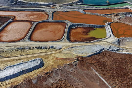Mining treatment ponds with brown water, geosynthetic liners, and dikes
