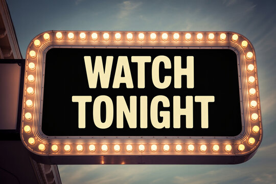 Vintage movie marquee sign, illuminated letters, watch tonight, cinema advertising, retro theater display