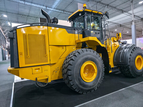 Yellow front loader displayed at a heavy machinery fair