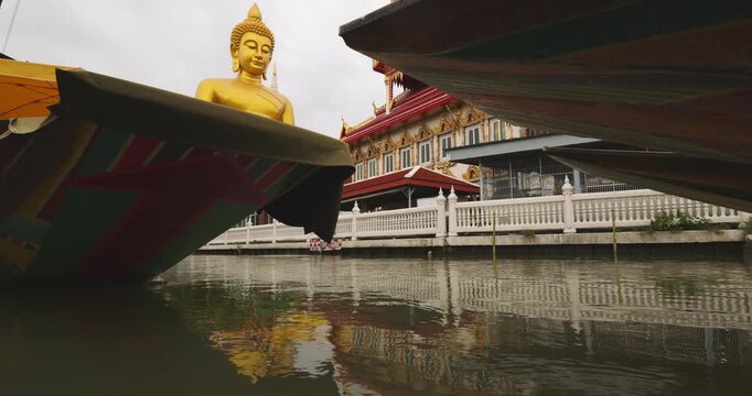 Big golden buddha statue at wat paknam phasi charoen with travel local wooden boat sightseeing travel in Bangkok Thailand
