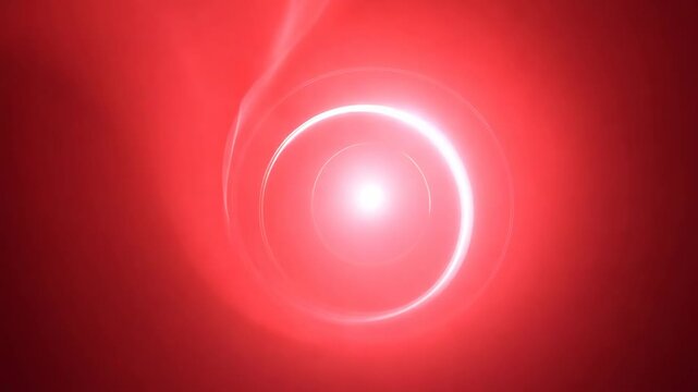 Circular red light gradually intensifies and expands, creating a glowing orb effect against a dark background, showcasing a mesmerizing visual transformation