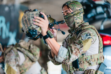 Tactical operator prepares and adjusts ballistic helmet and combat gear before mission deployment © SpaceOak