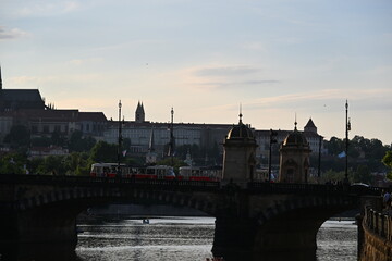 Obraz premium Sunset view over the Vltava River with bridges and boats in Prague