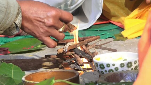 Close-up footage of a sacred Havan fire (Agni Kund) burning during a traditional Hindu wedding ceremony in India. The holy fire serves as a divine witness to the marriage and symbolizes purity.