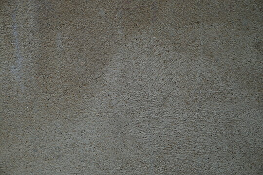 A rough grey concrete wall texture with a weathered stone pattern provides a grunge backdrop for construction design