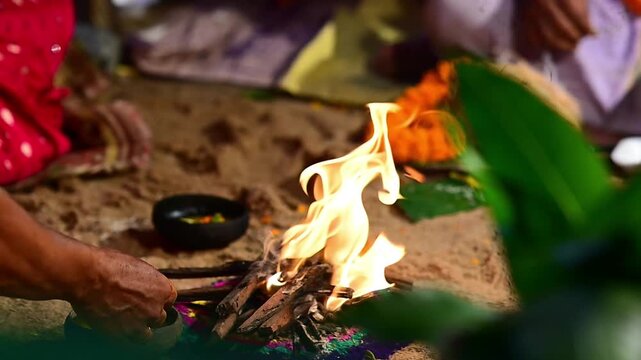 Close-up footage of a sacred Havan fire (Agni Kund) burning during a traditional Hindu wedding ceremony in India. The holy fire serves as a divine witness to the marriage and symbolizes purity.