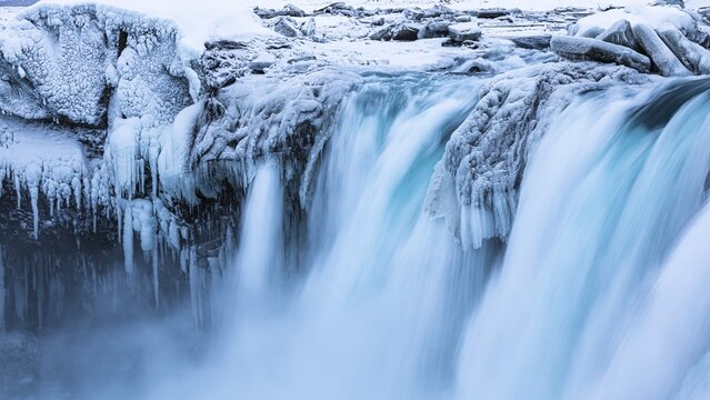 Godafoss waterfall, icy and snowy rock face, Northern Iceland Eyestra, Iceland