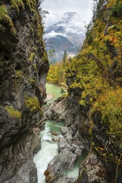 The River Lammer in the Lammerklamm gorge, view from the High Bridge, the footbridge over the river. The path through the gorge on the right. The Tennengebirge mountains in the background. Autumn. Scheffau, Lammertal, Salzburger Land, Upper Austria, Austria