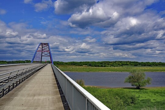 Bridge over a river under a cloudy blue sky, surrounded by green landscape, D&ouml;mnitzer Br&uuml;cken, Wendland, Lower Saxony, Germany