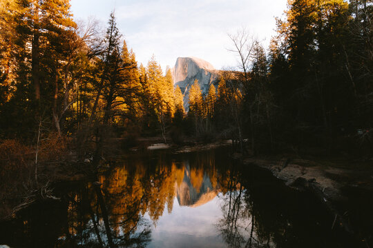 Half Dome reflecting in Merced River at golden hour