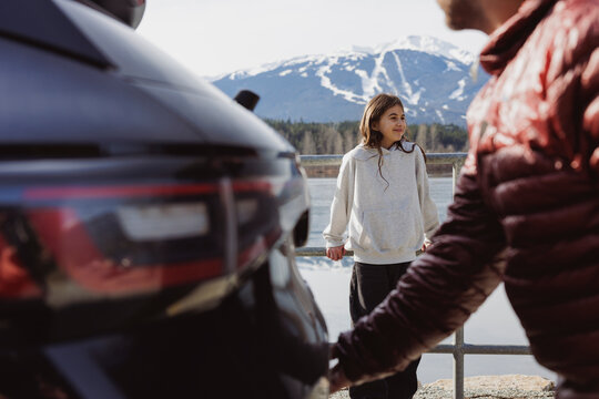Young girl on a scenic stop with family and EV
