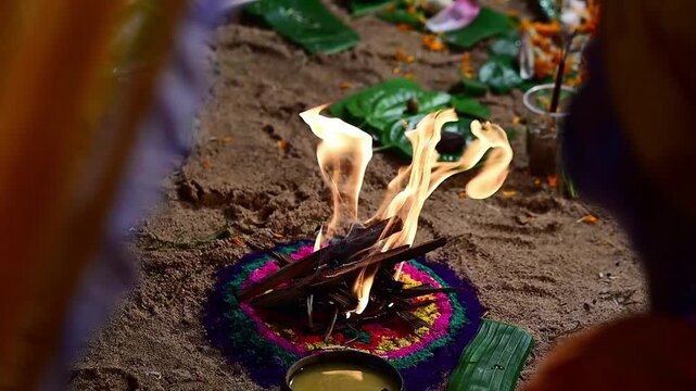 Close-up footage of a sacred Havan fire (Agni Kund) burning during a traditional Hindu wedding ceremony in India. The holy fire serves as a divine witness to the marriage and symbolizes purity.