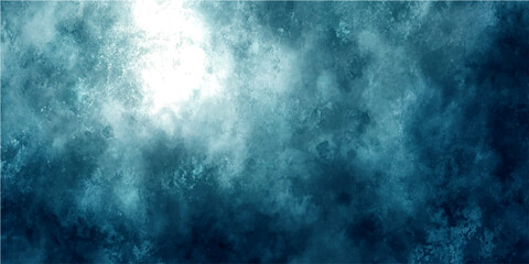 Abstract textured background resembling swirling dark blue and turquoise smoke or clouds, with bright light emanating from upper left corner. © Ateş