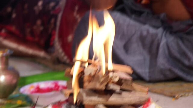 Close-up footage of a sacred Havan fire (Agni Kund) burning during a traditional Hindu wedding ceremony in India. The holy fire serves as a divine witness to the marriage and symbolizes purity.