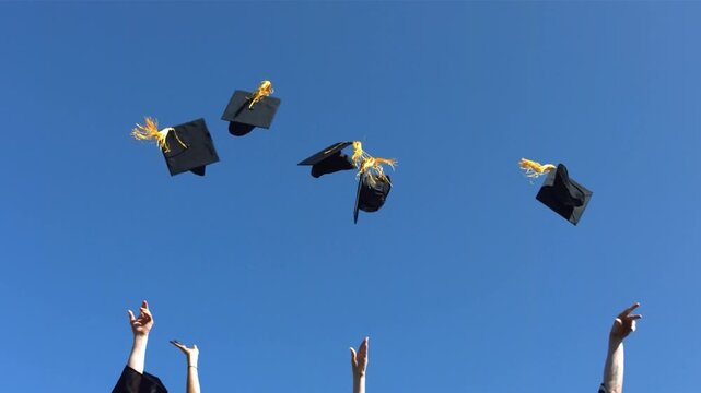 Students, happy and throw hats for graduation, celebration and success with education at college. People group and goals with cap, scholarship and achievement at university campus. outdoor blue sky
