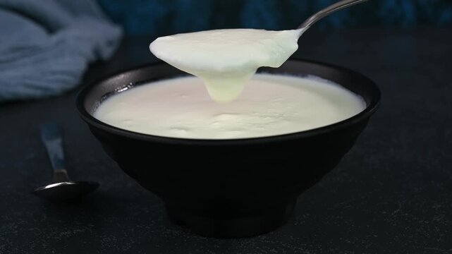 Serving dahi or curd in a bowl.