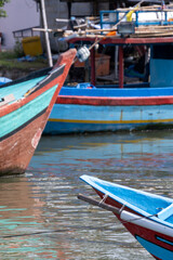 Obraz premium Traditional wooden fishing boats moored side by side in a harbor in Cilacap, Indonesia.