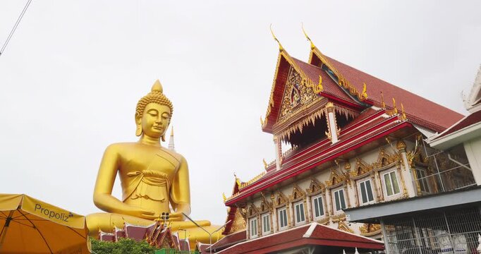 Big golden buddha statue at wat paknam phasi charoen with travel local wooden boat sightseeing travel in Bangkok Thailand