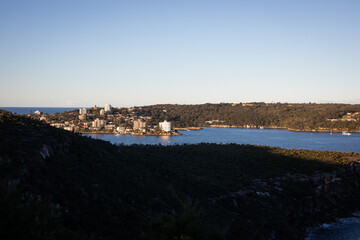 Obraz premium Coastal Cityscape View Under Clear Blue Sky