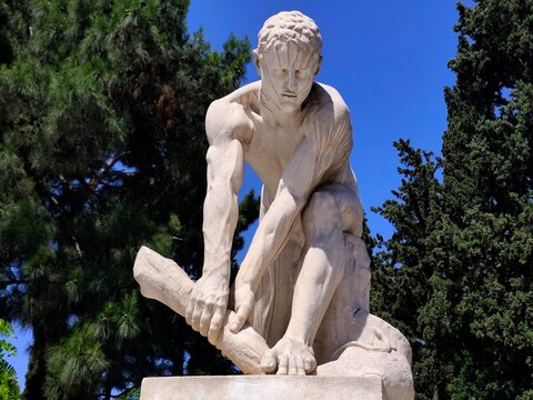 Photo of the marble sculpture "The Woodbreaker" (Xylothraustis), a famous work by the Tinian sculptor Dimitrios Filippotis, created in 1901.