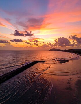 Serene beach at sunset with calm waves.