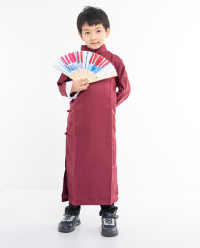 Smiling cute Asian boy in traditional Chinese clothing