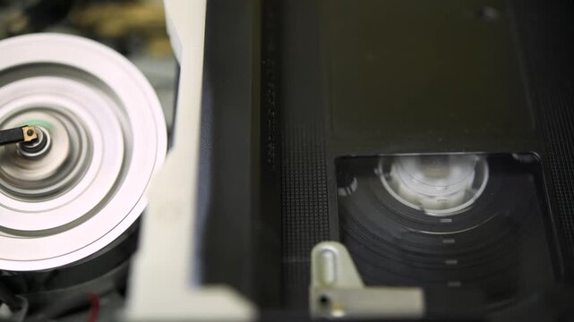 Operation of the mechanism for loading and unloading film in a VHS video recorder