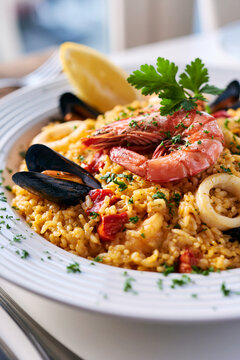 Closeup seafood paella with shrimp, mussel and lemon