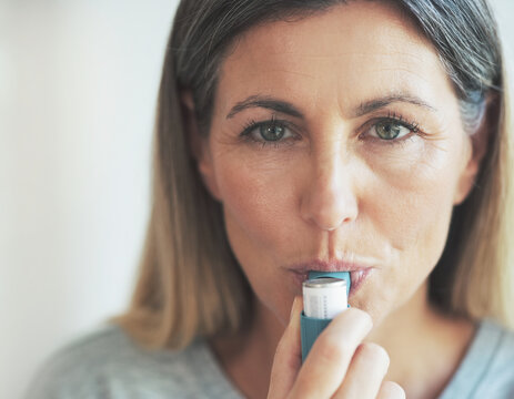 An adult female patient demonstrating compliance with a prescribed daily respiratory management routine during a clinical observational study session