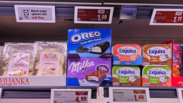 Supermarket shelf displaying oreo, milka, exquisa products for sale