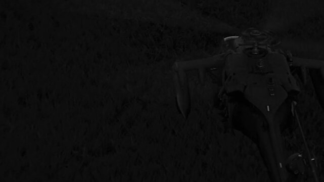 Helicopter flying slowly in the sky at night